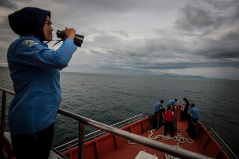 A member of Indonesia's National Search and Rescue looks over horizon during a search for the missing Malaysian Airlines MH370 plane on March 17, 2014