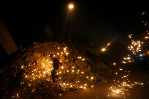 People gather for the iftar, or fast-breaking meal, on the first day of the Muslim holy fasting month of Ramadan in Jabalia in the northern Gaza Strip