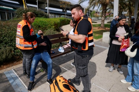 A man receives food aid from a UN distribution centre in central Gaza after Israel announced a block on aid flows into the territory