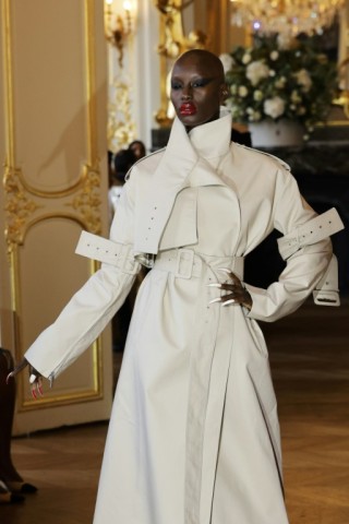 A model presents a trench coat by Matieres Fecales 