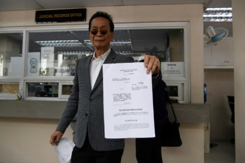 Salvador Panelo, lawyer of Rodrigo Duterte, shows a copy of his petition to the Supreme Court demanding the former Philippine president's return