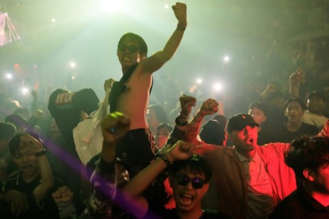 Revellers enjoy the music during an event by Weekenders Service Crew, a DJ collective in Indonesia