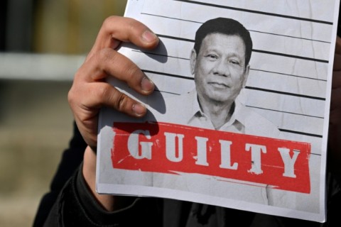 Protestors rally outside the detention centre holding former Philippine president Rodrigo Duterte in The Netherlands