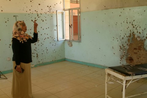 Hospital director Dr. Safaa Ali shows the bullet holes that still riddle the wards of the reopened Saudi hospital in Omdurman.
