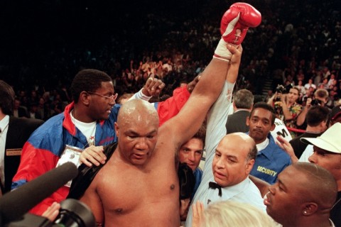 George Foreman raises his arm aloft after defeating Michael Moorer to recapture the heavyweight title in 1994