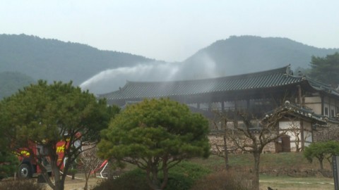 South Korean firefighters spay water and fire retardants onto the UNESCO-listed Byeongsan Seowon