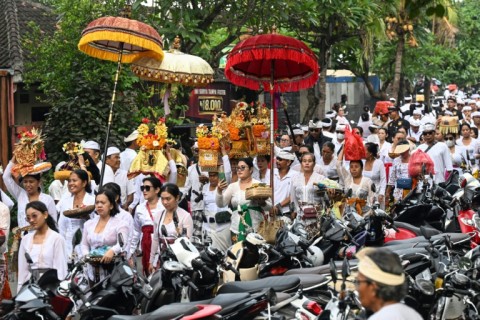 Balinese parade with offerings for prayers during the Melasti ritual that precedes Nyepi