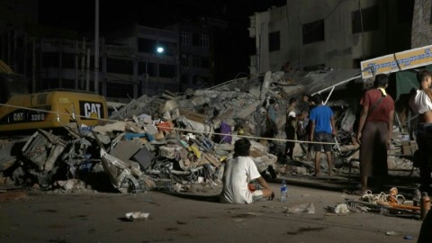 People gather at collapsed building site after Myanmar quake