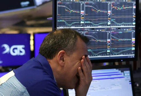 A trader winces on the floor of the New York Stock Exchange on April 4, 2025, during one of the market's worst days in years, following US President Donald Trump's imposition of import tariffs on much of the world