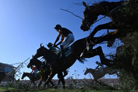 Patrick Mullins (C) jumps The Chair on Nick Rockett on the first circuit on his way to winning the 2025 Grand National