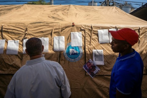Families checked lists with the names of victims posted outside the club as they awaited news of their loved ones