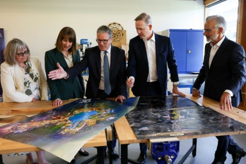 Britain's finance minister Rachel Reeves and Prime Minister Keir Starmer, second and third from left, examine plans for the new Universal park with Comcast president Mike Cavanagh
