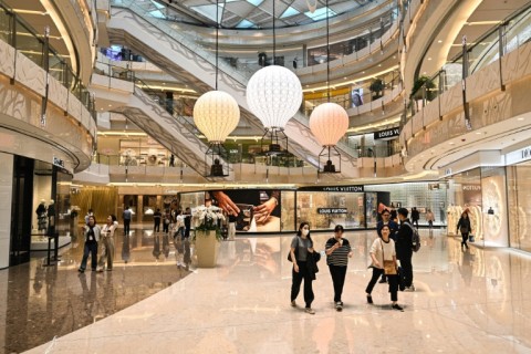 People walk in the IFC mall at the financial district in Shanghai