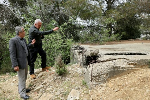 In the town of Souk al-Gharb, overlooking Beirut, former fighters from different backgrounds walk through grass covering the old front line to an abandoned bunker