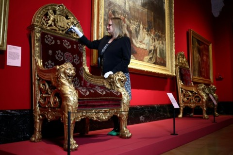 A throne chair and the painting 'The Marriage of George, Duke of York, with Princess Mary of Teck