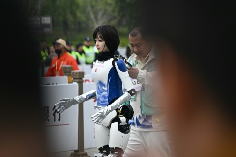 Dozens of humanoid robots took to the streets of Beijing, joining thousands of their flesh-and-blood counterparts in a world-first half marathon