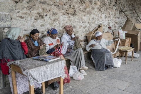 Patients at the hospital weave cotton