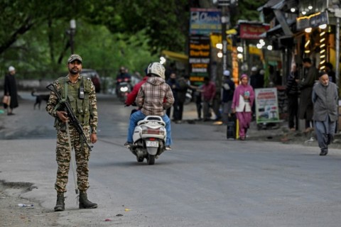 A member of the Indian paramilitary stands guard near Pahalgam, south of Srinagar following an attack on tourists