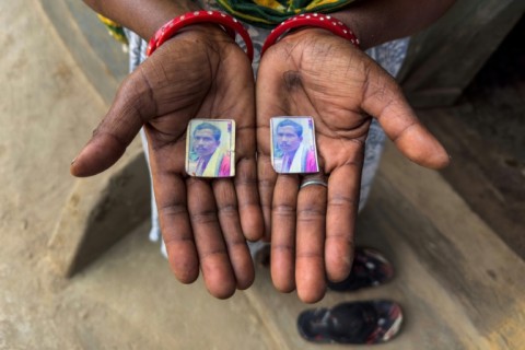 The widow of Suresh Teta, killed last year by police, with pictures of her husband