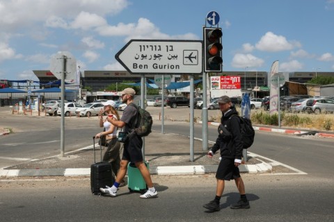 Travellers enter Israel's Ben Gurion airport after air defences were activated against a missile launched from Yemen