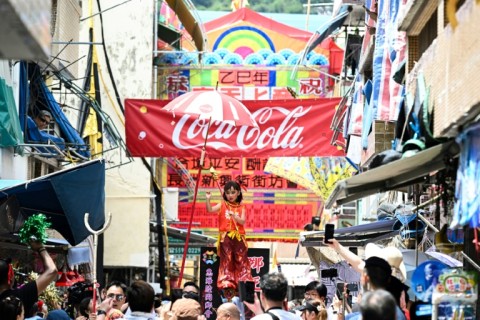 A child participates in the "Piu Sik" parade on the island of Cheung Chau during its annual Bun festival in Hong Kong