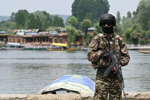 An Indian paramilitary personnel stands guard in Srinagar