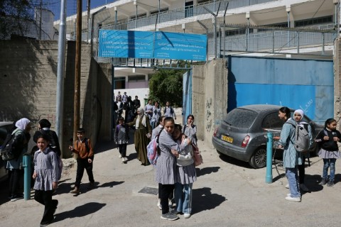 Palestinian schoolgirls leave a UNWRA school in the Shoafat refugee camp in east Jerusalem