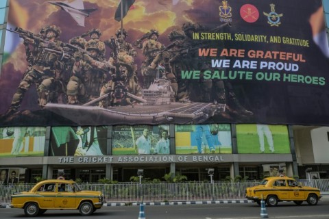 Taxis drive past a hoarding on the main gate of Eden Gardens in Calcutta acknowledging the efforts of the Indian armed forces during the recent India-Pakistan conflict