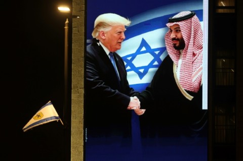 A billboard bearing a picture depicting US President Donald Trump shaking hands with Saudi Crown Prince Mohammed bin Salman is displayed on a hotel building in Jerusalem