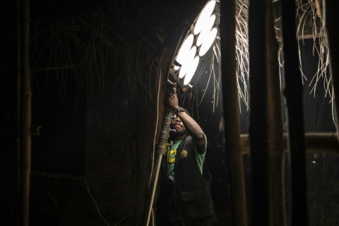 Nollywood dream factory: a studio worker carries a light on a set in Lagos, Nigeria