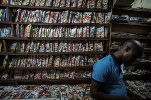 A customer in front of a shelf full of Nollywood movies in a Lagos shop
