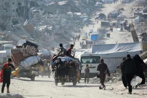 Palestinians move through Jabalia as they flee the northern Gaza Strip after Israel told them to evacuate