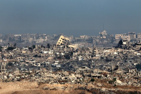 This picture taken from a position in southern Israel shows destroyed buildings in the Gaza Strip