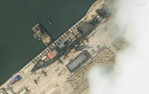 This handout satellite image from Maxar Technologies shows a general view of a new North Korean warship at a harbour ahead of its launch