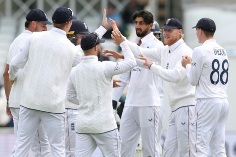England's Shoaib Bashir (C) celebrates after dismissing Zimbabwe's Ben Curran for 37 in a one-off Test at Trent Bridge