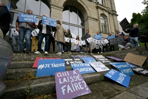 Survivors of French surgeon Joel Le Scouarnec's abuse staged a protest outside the court in Vannes in the western region of Brittany, holding signs such as "Never again" and "I accuse you"