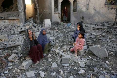 Palestinians gather in the rubble of a building hit by an overnight Israeli strike on Jabalia in central Gaza.