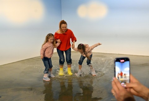 The exhibition allows visitors to splash in man-made puddles