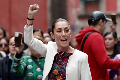 Mexican President Claudia Sheinbaum greets supporters outside a polling station