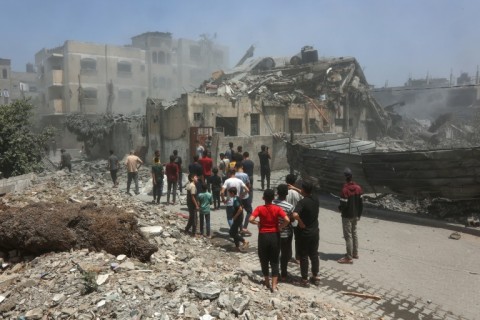 Palestinians inspect the rubble following Israeli strikes on a family home in Al-Tuffah neighbourhood in Gaza City