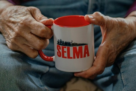 Joyce Ellwanger sips tea from a mug reading 'Selma,' commemorating the 1965 marches from Selma to Montgomery in the southern US state of Alabama