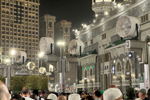 Big fans blow air as Muslim worshippers gather at the Grand Mosque in Mecca