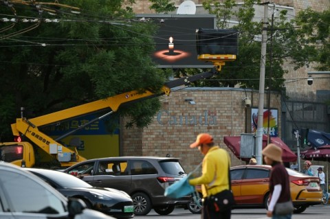 In Beijing, a cherry picker blocked a screen at the Canadian embassy showing an image of a candle, the symbol commonly used to pay tribute to Tiananmen victims