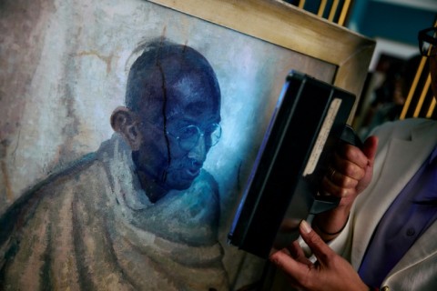 Rhyanon Demery shows the spot where Clare Leighton's portrait of Mahatma Gandhi was damaged