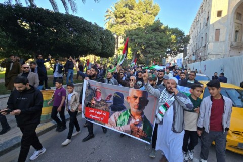 Demonstratos in Libya carry a poster showing slain Hamas leader Yahya Sinwar, during a rally in Tripoli