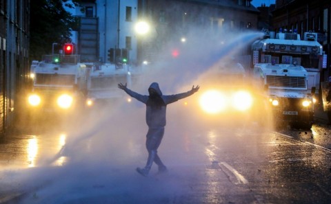 Riot police use a water cannon in an attempt to disperse protestors in Ballymena, Northern Ireland