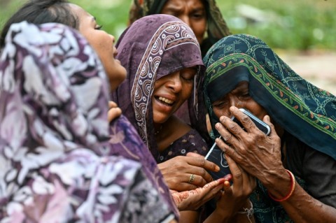 Relatives mourn for Akash Patni, a 14-year-old boy killed on the ground when the Air India jet crashed into buildings in a residential area of Ahmedabad