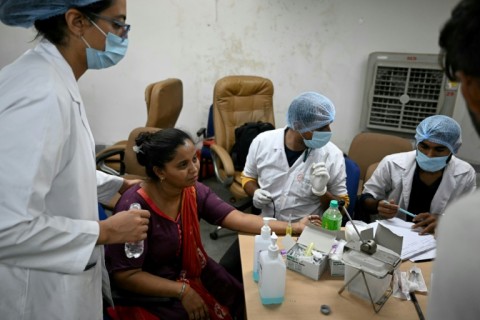 Medics collect a DNA sample from a relative of a passenger aboard the crashed plane