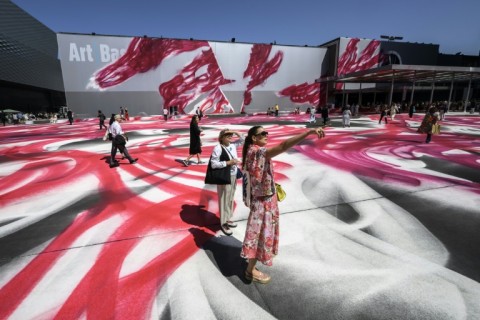 Visitors walk on the artwork 'Choir' by the German artist Katharina Grosse at the Art Basel fair entrance