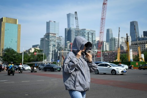 Beijing officials encouraged people to limit outdoor activity and drink fluids to avoid heastroke